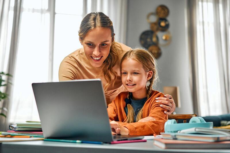 Happy mom teaching children at home